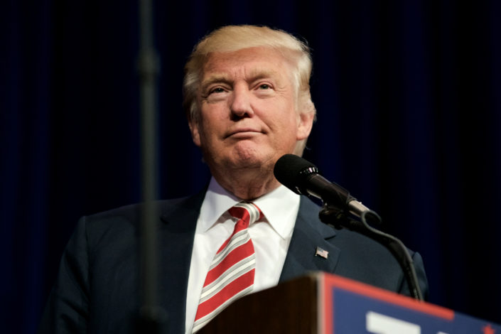 Presidentti Donald Trump hymyilee keveästi lähikuvassa.