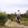 Mies ajaa polkupyörällä Indonesian maaseudulla.