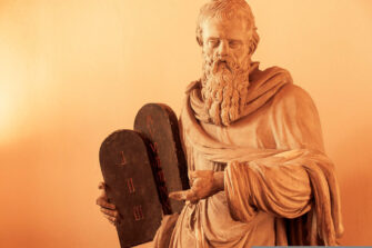 Mooses-patsas, joka pitää käsissään kymmenen käskyn laintauluja.