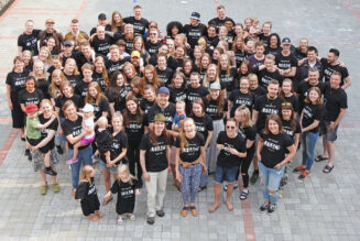 Kuva on otettu korkealta yläviistosta. Siinä näkyy kymmeniä nuoria ja lapsia, joiden päälllä on musta t-paita. T-paidassa lukee Legacy. Nuoret ovat lähdössä aktioihin eri puolelle Suomea ja Eurooppaa.