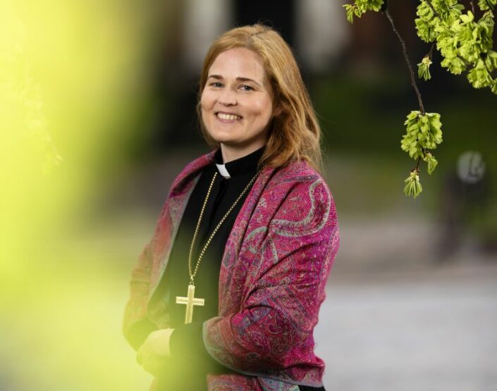 Piispa Mari Leppänen syksyn lehtien ympäröimänä ruskan väreissä. Kuva: Jani Laukkanen