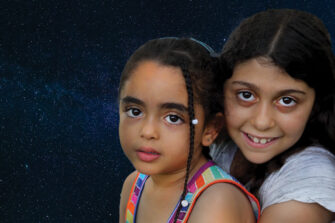 kaksi israelilaista tyttölasta istuu tähtitaivaan alla
