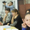 a_deaf_woman_making_victory_sign_with_hands_in_class_photo_Jussi_Valkeajoki.jpg