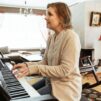 Elina Uusikylä soittaa pianoa ja laulaa.