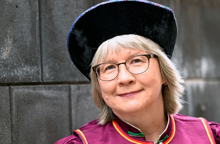 a_woman_looking_at_camera_smiling_photo_Saija_Tiilikainen